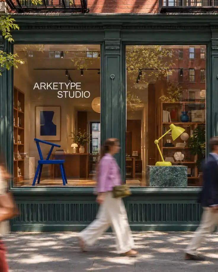 People walking past a design boutique storefront