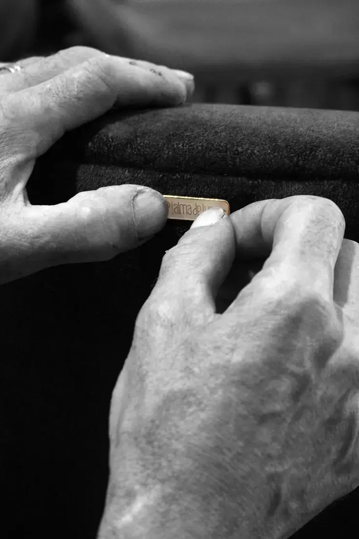 Craftsman fixing a brand nameplate by hand
