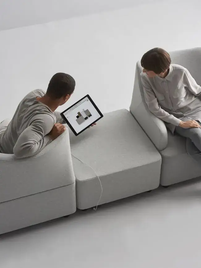Two strategists reviewing brand work on a tablet in the studio