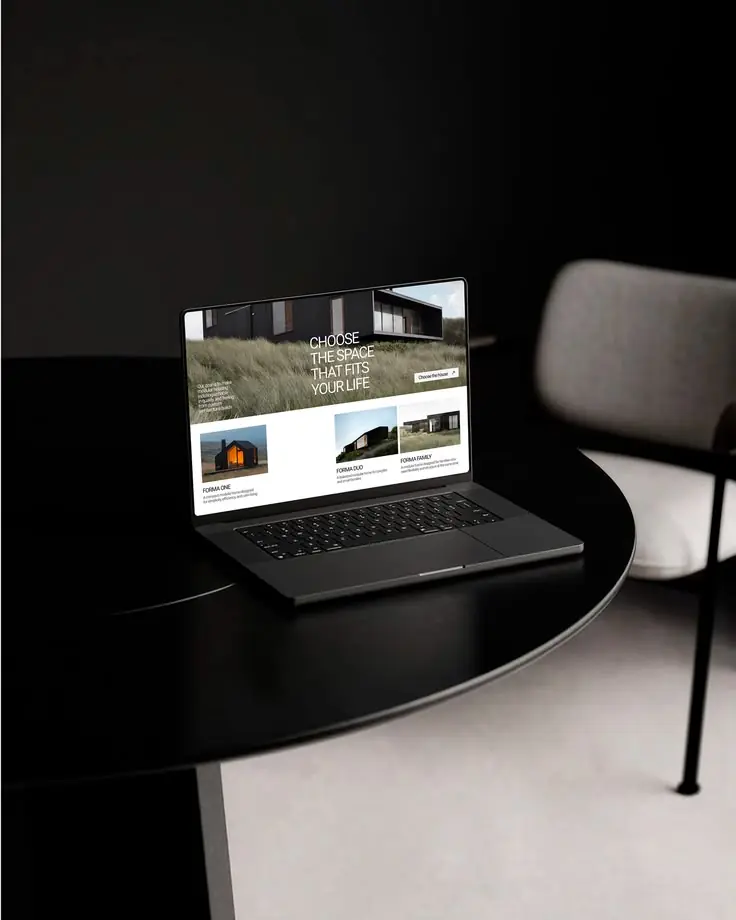 Laptop on a dark table showing a newly launched brand website