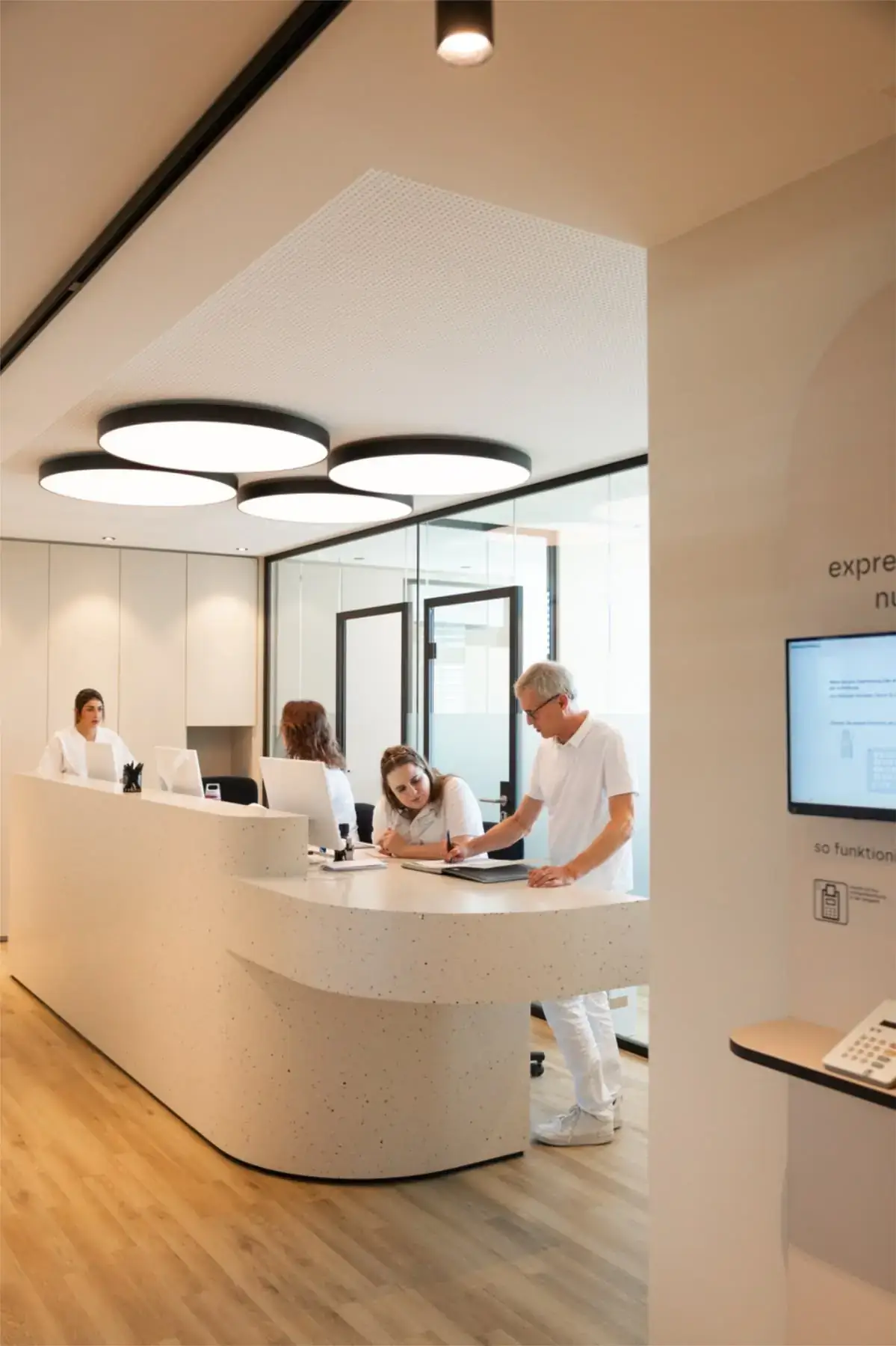 Clinic front desk team checking in a patient