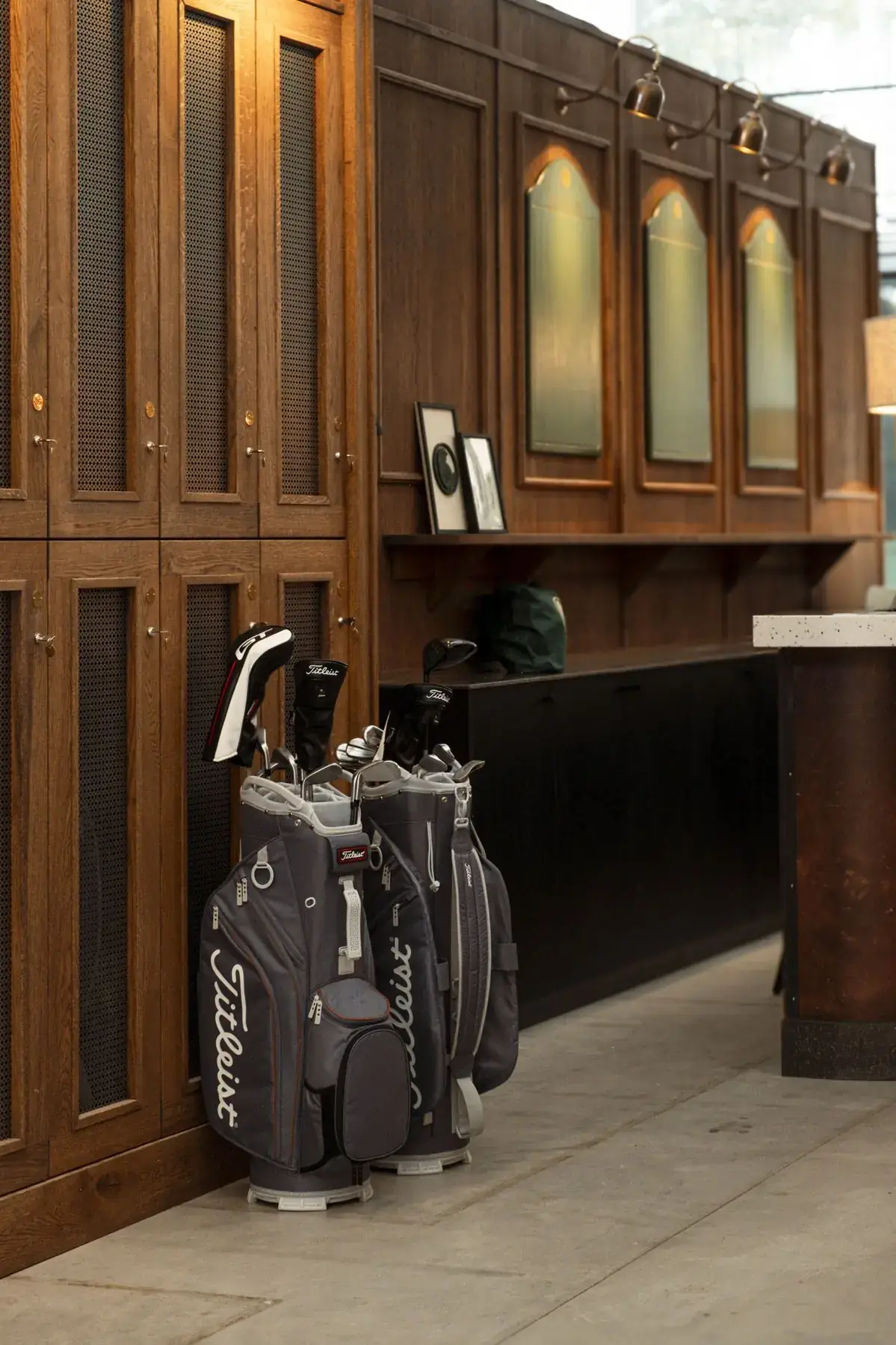 Golf bags beside wooden lockers in a golf club