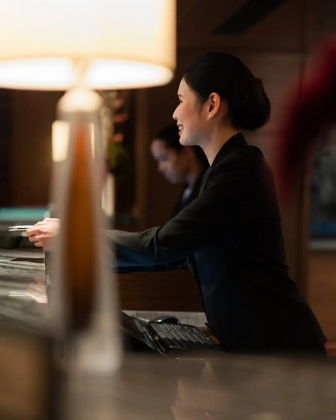 Front desk host welcoming a guest