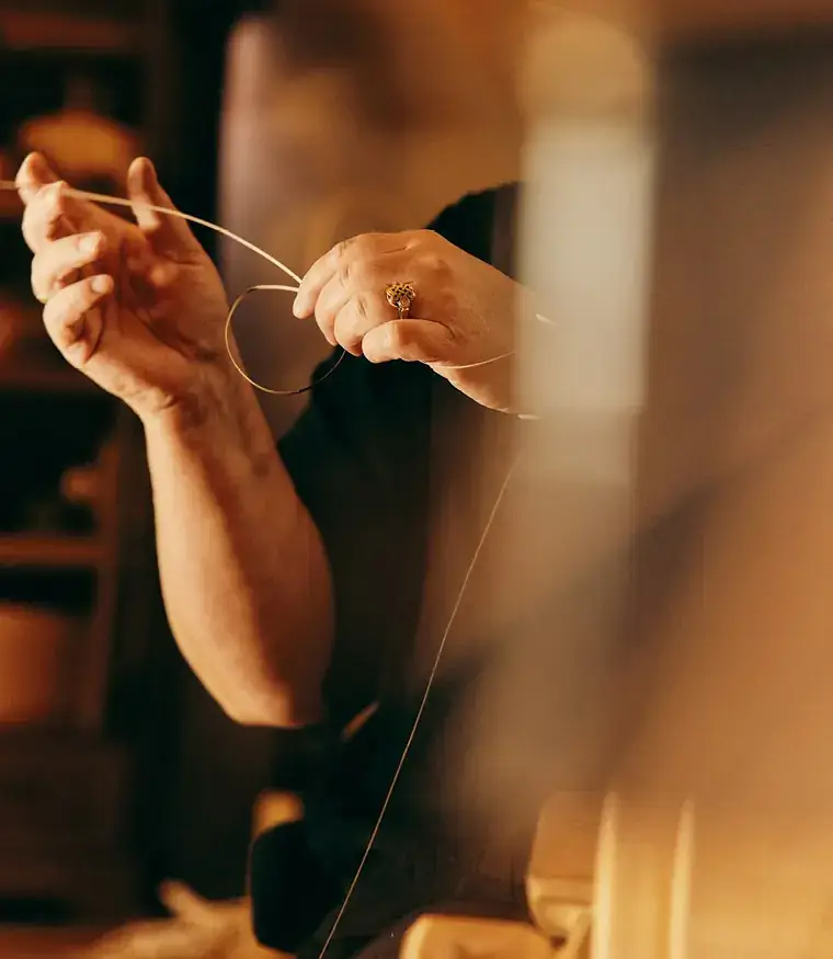 Artisan's hands working with fine thread