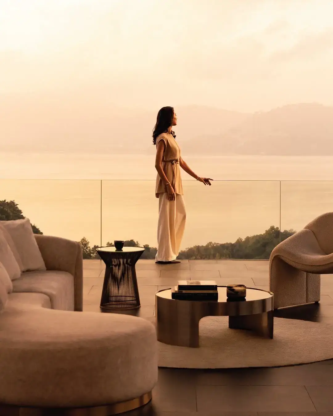 Woman on the terrace of a luxury apartment at sunset