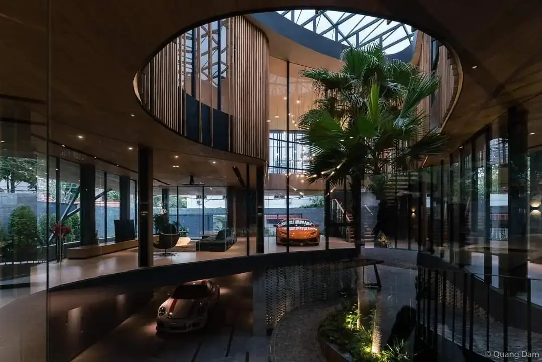 Double-height atrium of a luxury home with glass and timber
