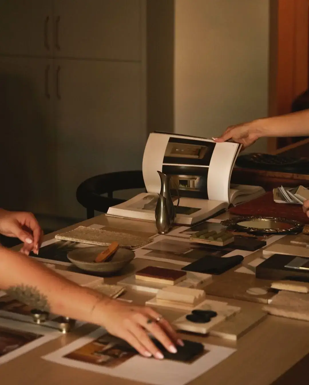 Material samples and printed images laid out for a moodboard