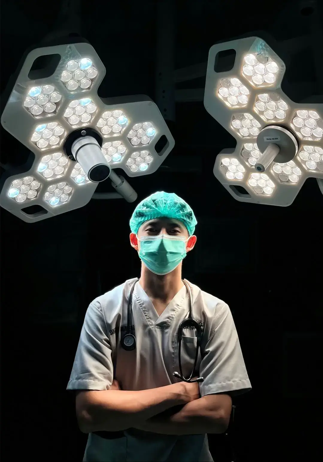 Surgeon in scrubs under operating theatre lights