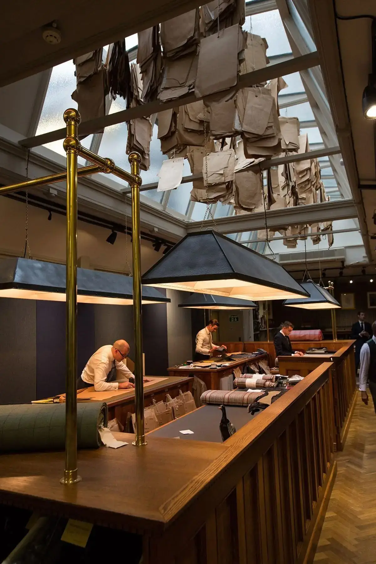 Tailors cutting cloth in a traditional tailoring house